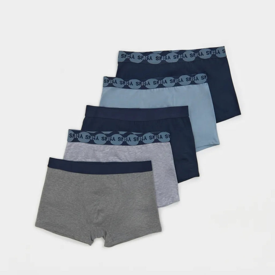 Five pairs of men's boxer briefs from SHHA, arranged in a fan shape on a light gray background. The colors range from heather gray and navy blue to light blue and dark navy, with the waistbands featuring a repeating SHHA logo pattern.