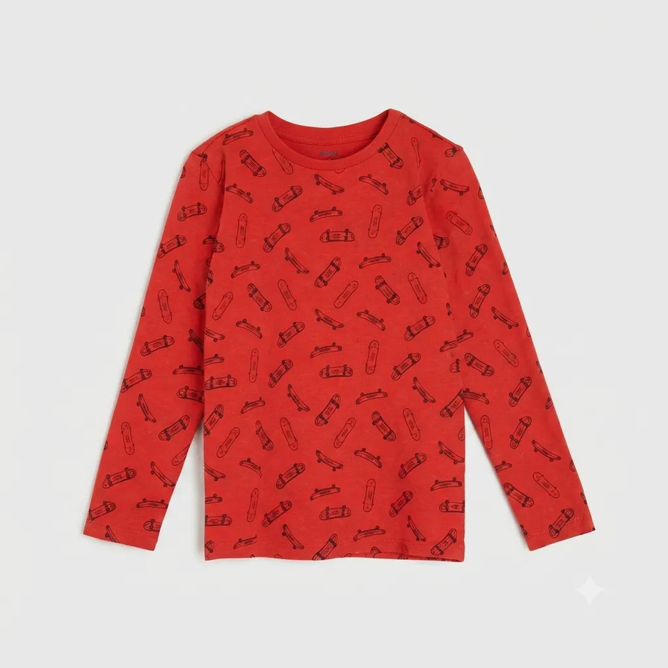 A red long-sleeve crewneck shirt for kids, featuring an all-over pattern of small black skateboard illustrations, displayed flat against a light gray background.