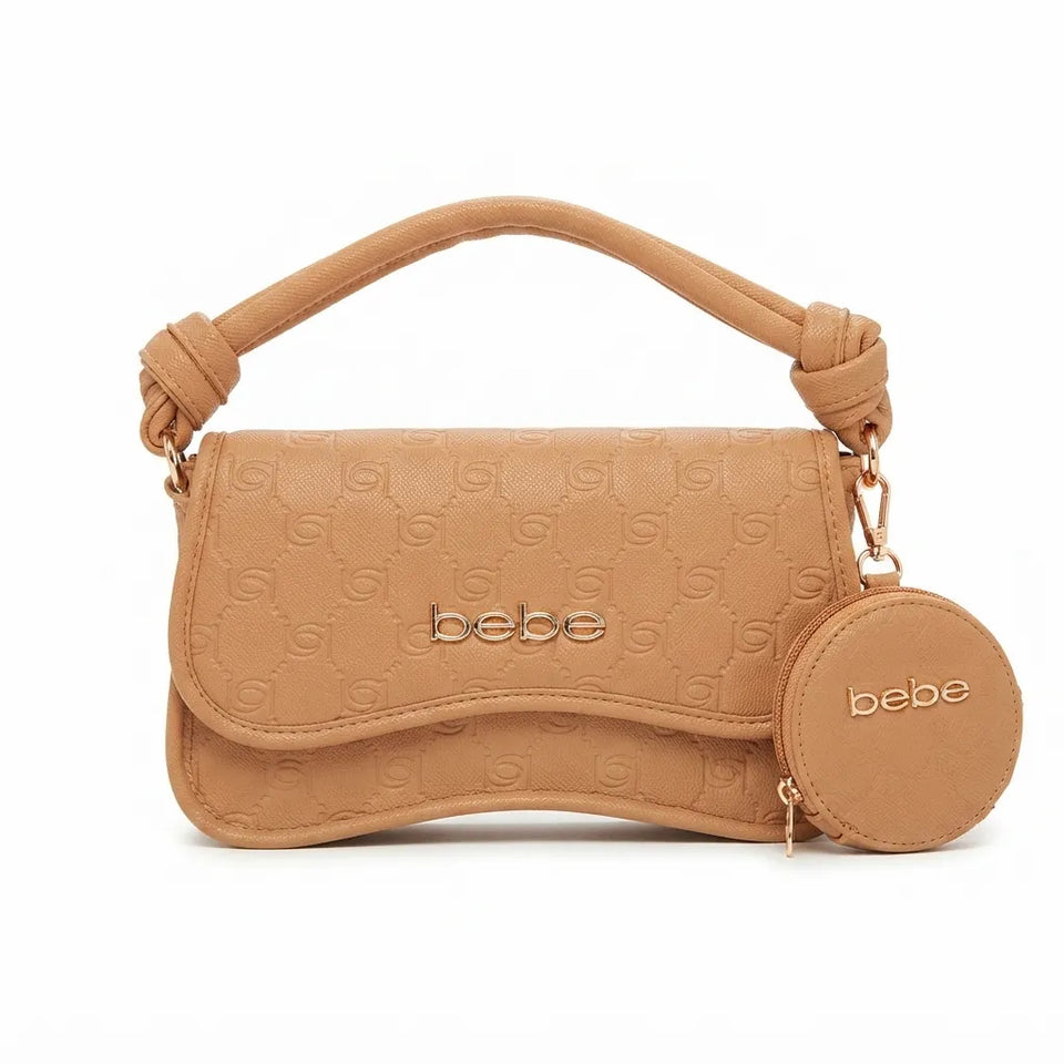 A tan leather handbag with an embossed monogram pattern, a knotted top handle, and a matching round coin pouch hanging from the side, both featuring the 'bebe' brand name in gold lettering.