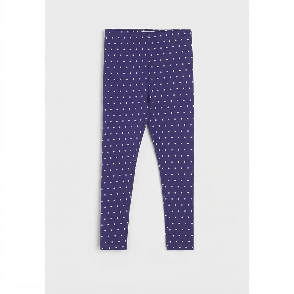 A pair of dark purple leggings with a white polka dot pattern, laid flat against a light gray background.