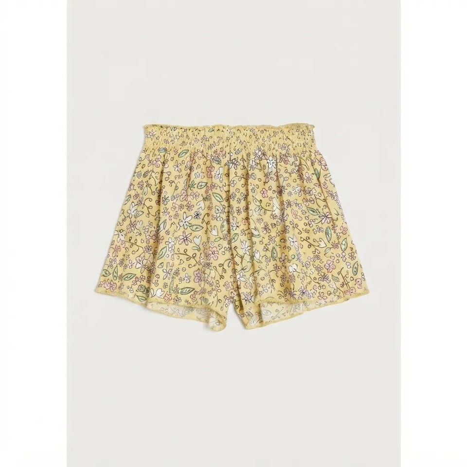 Yellow floral print shorts with a smocked waistband, shown flat on a light gray background.