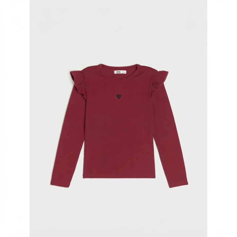 A long-sleeve burgundy top with ruffled shoulder details and a small dark heart emblem on the chest, displayed flat against a light gray background.