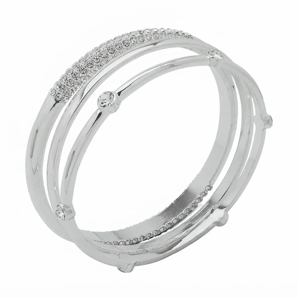 A silver-toned multi-band ring with a curved top band paved with small clear stones, shown on a plain white background.