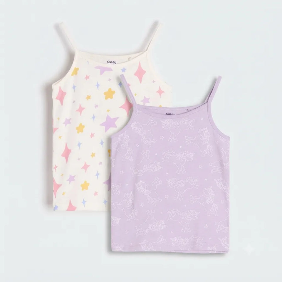 Two girls' camisole tank tops by babytodd, shown flat against a light gray background. The top on the left is off-white with pastel pink, yellow, and blue star prints.