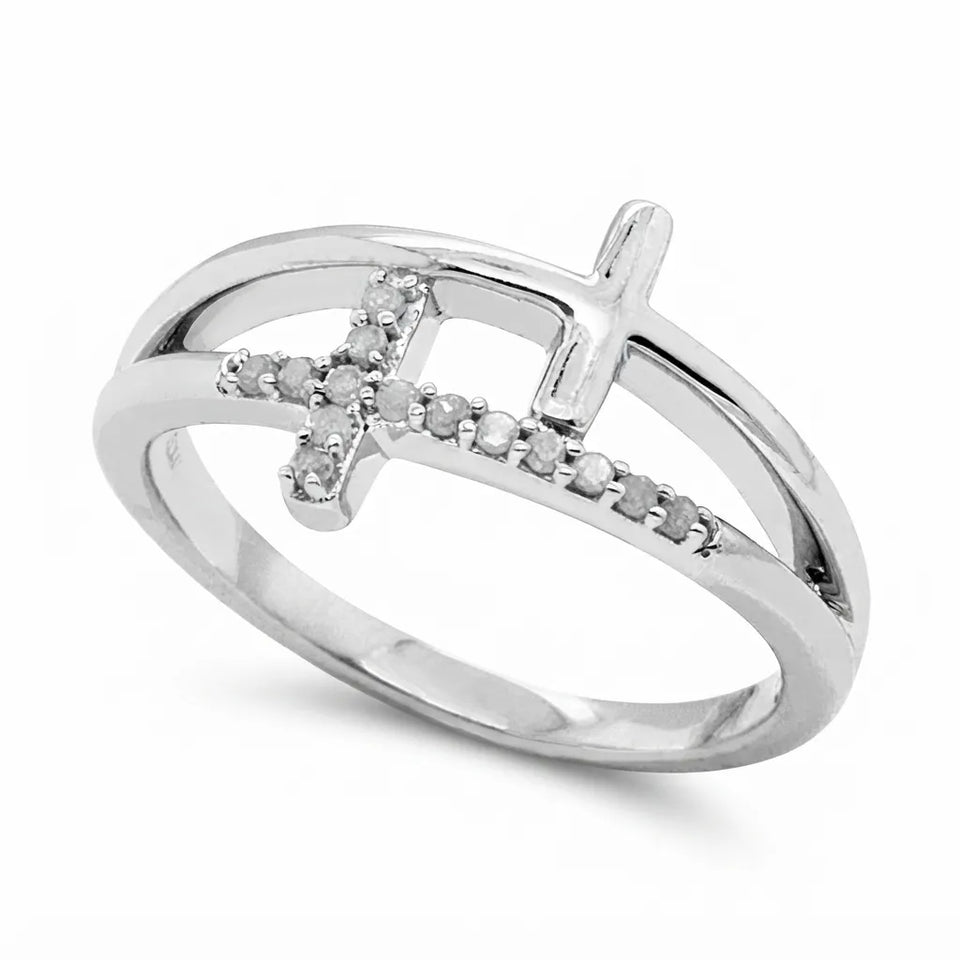 A silver ring featuring a double cross design, with one cross adorned with small clear stones, set against a plain white background.