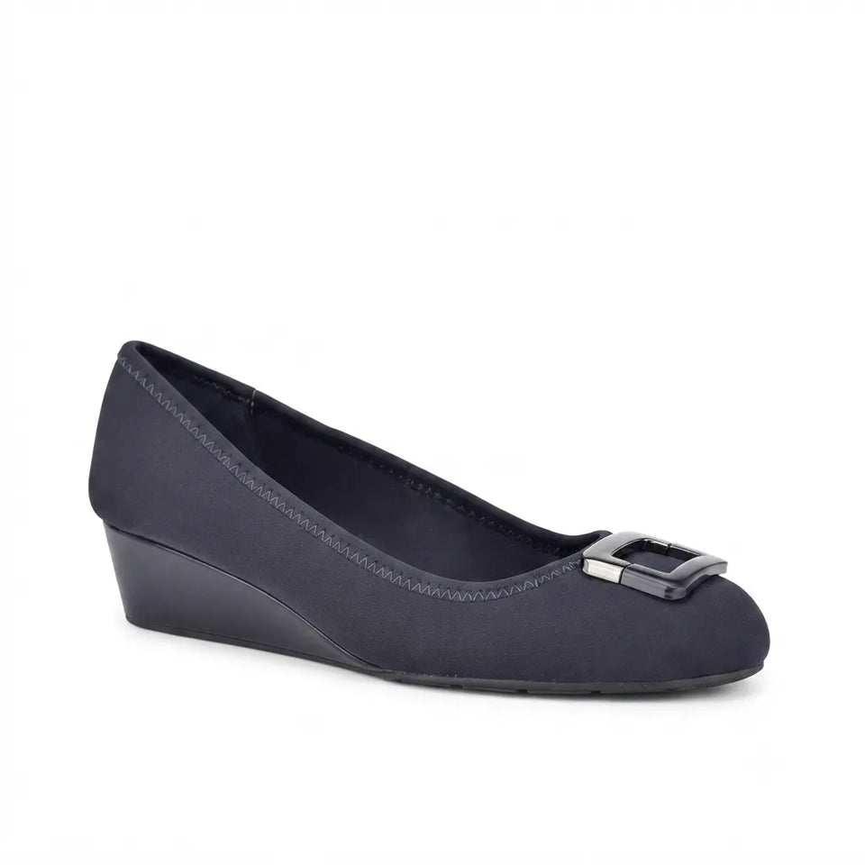 A single women's wedge pump in dark navy blue suede, featuring a silver-tone metal square buckle on the toe box, shown against a plain white background.