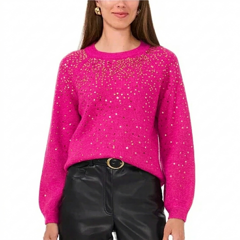 Person wearing a bright pink sweater with a star pattern on a white background