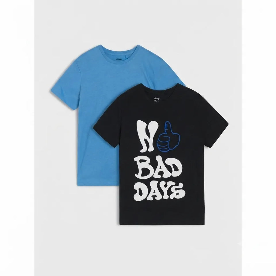 Two short-sleeve crewneck t-shirts displayed flat against a light gray background. The front shirt is black with a graphic print reading 'BAD DAYS' in white and blue, and the shirt behind it is solid light blue.