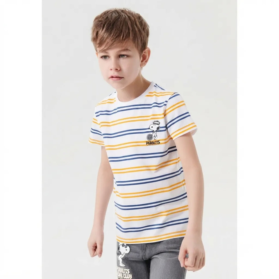 A young boy wearing a white short-sleeve t-shirt with yellow and navy blue horizontal stripes, featuring a small cartoon character on the left chest. He is also wearing gray jeans with a white graphic print.