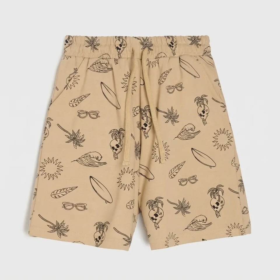 Beige swim shorts with an all-over black line-art print of surfboards, palm trees, sunglasses, and skulls, shown flat against a light gray background.