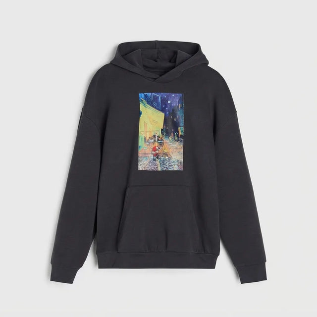 A dark gray pullover hoodie featuring a colorful graphic print of Van Gogh's 'Starry Night' on the chest, displayed against a light gray background.