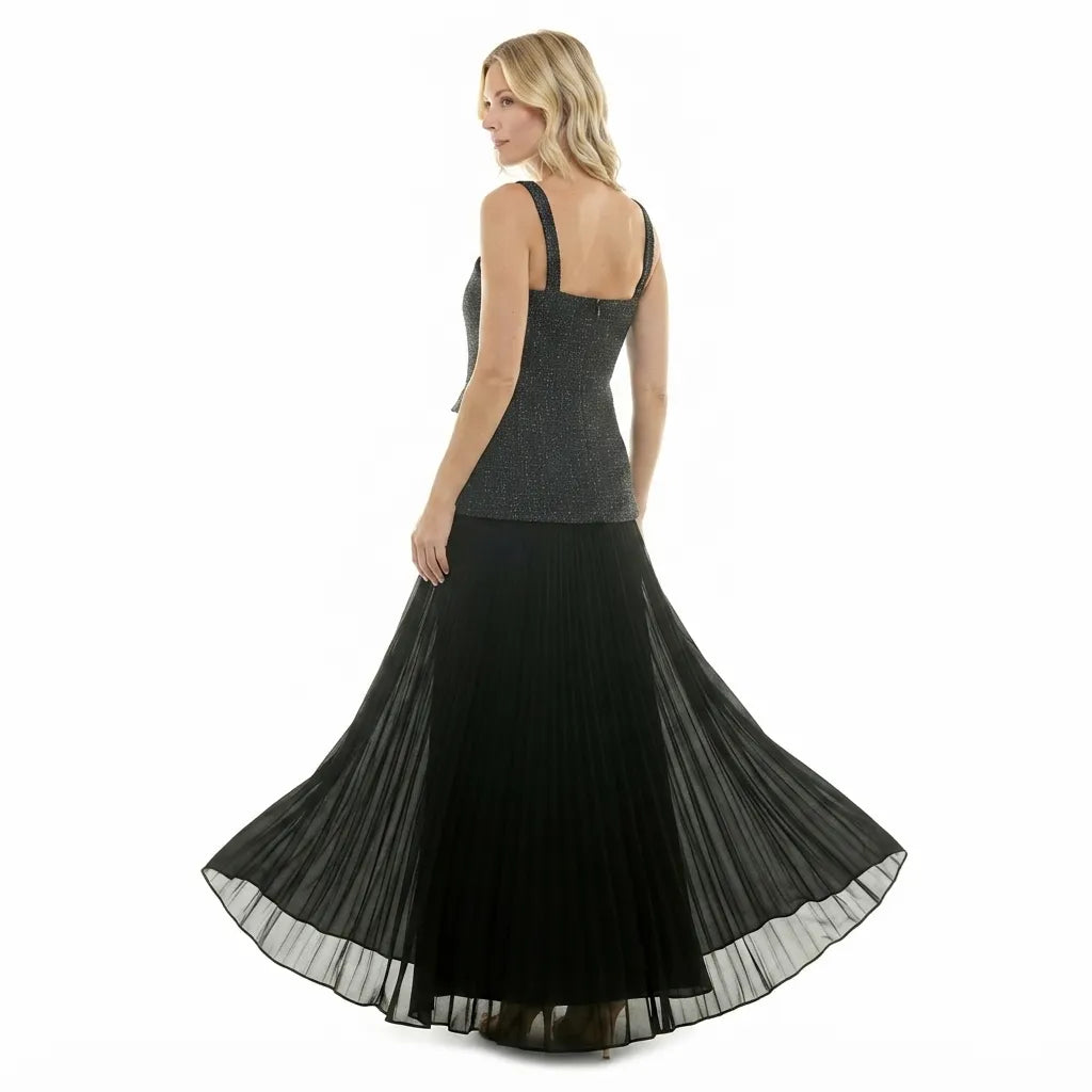 A woman modeling a sleeveless maxi dress from the back, featuring a textured charcoal gray bodice and a flowing black pleated skirt, set against a plain white background.