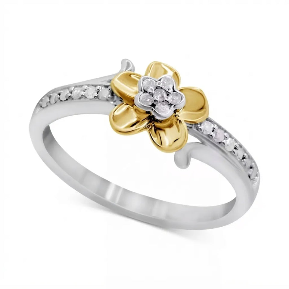 A two-tone flower ring featuring a gold flower with a small cluster of clear stones in the center, set on a silver band with small pavé-set stones.