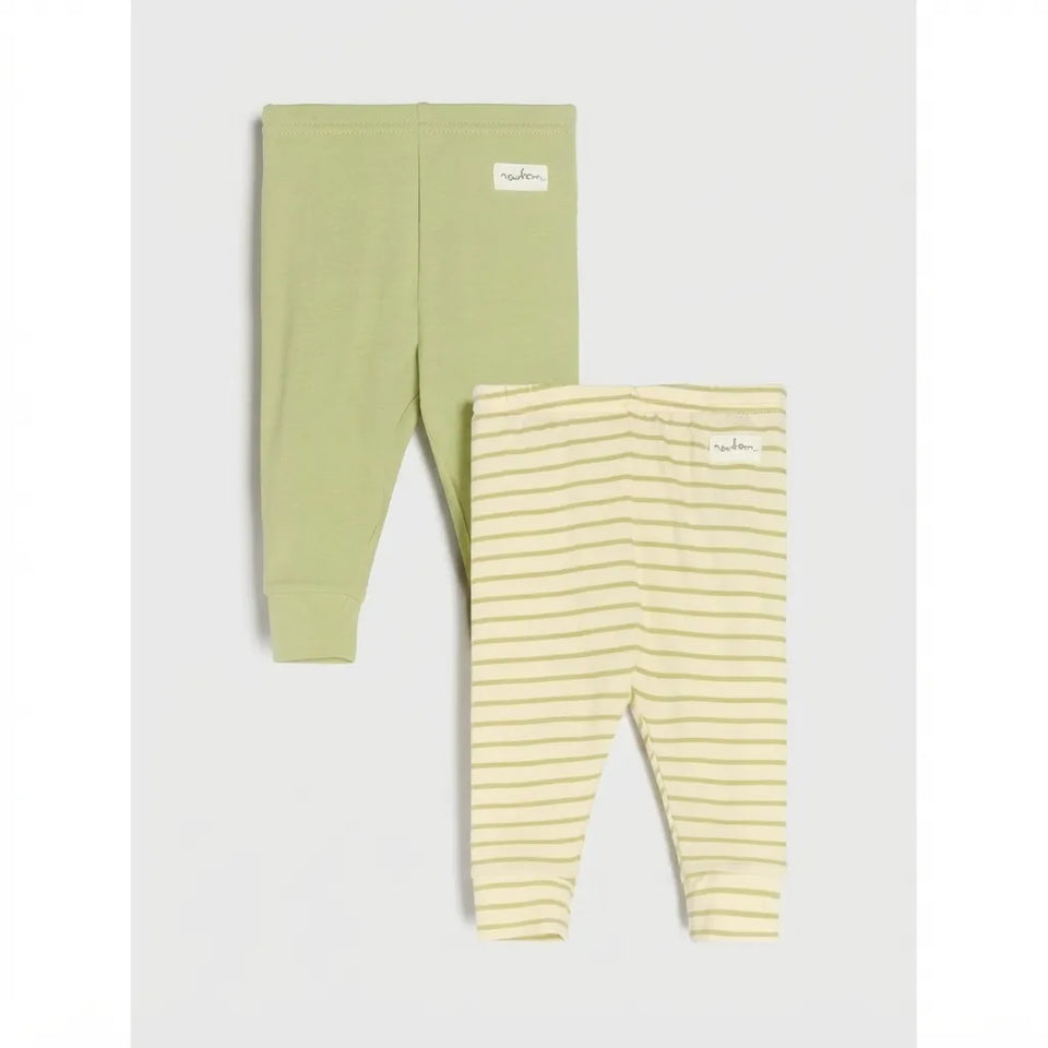 Two pairs of children's leggings from the brand Nuna, displayed flat against a light gray background. The top pair is a solid light sage green, and the bottom pair is a pale yellow with thin horizontal green stripes.