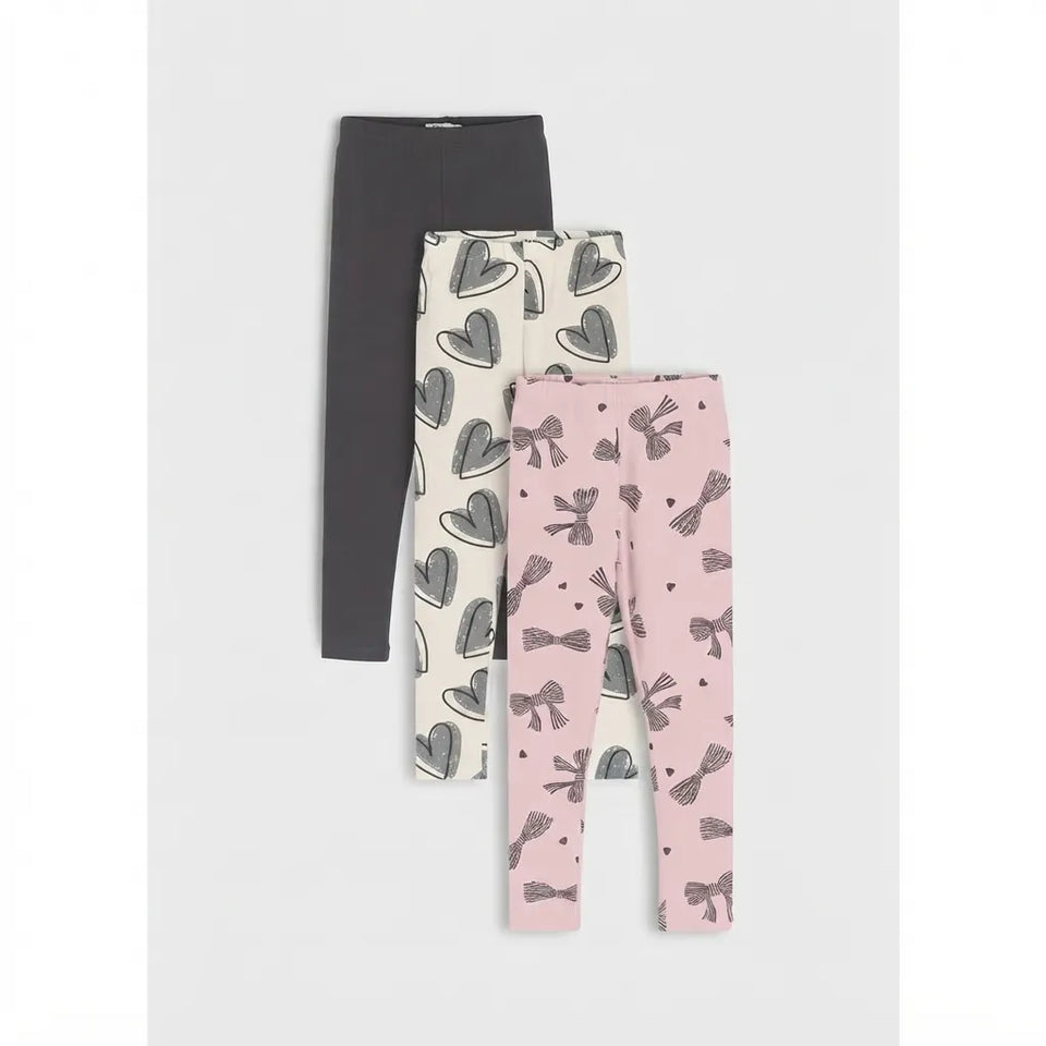 Three pairs of children's leggings displayed in a vertical stack on a light gray background. The top pair is solid dark gray.
