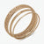 A set of three rose gold bangles with a woven textured pattern and small clear rhinestone accents, displayed on a clean white background.