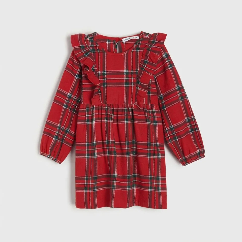 A red plaid long-sleeve dress for toddlers, featuring ruffled shoulder details and a gathered waist, shown against a light gray background.