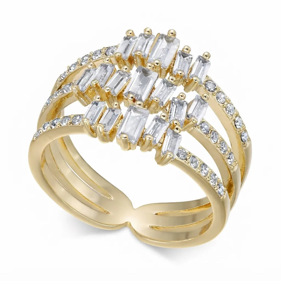 A gold multi-band ring featuring baguette and round clear gemstones, set against a plain white background.
