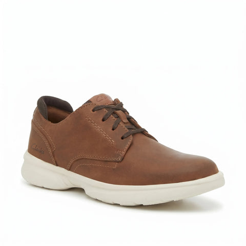 Brown leather shoe with white sole on a white background