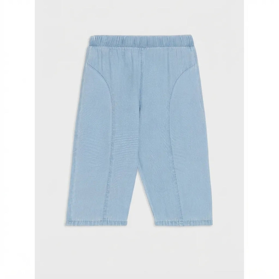 Light blue cropped pants with an elastic waistband and curved seam details, shown flat against a light gray background.