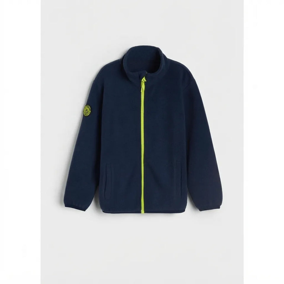 A navy blue fleece zip-up jacket with a bright neon yellow-green zipper and a matching logo patch on the left sleeve, displayed against a light gray background.
