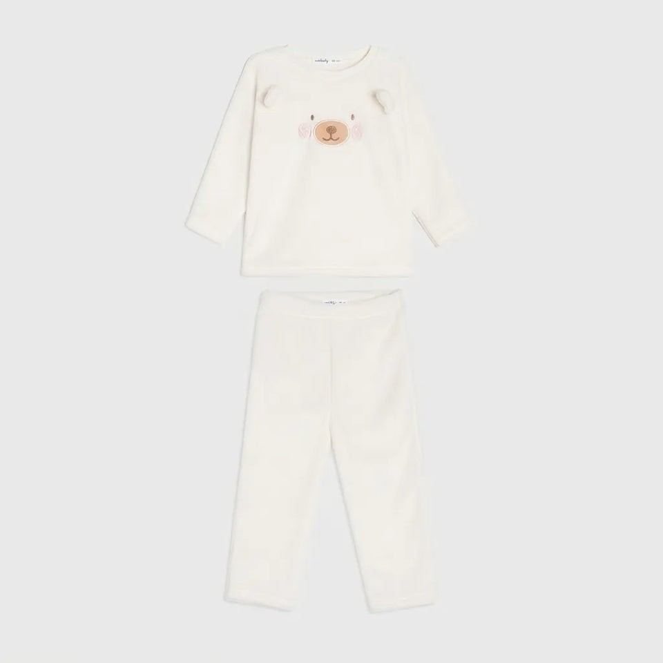A two-piece baby pajama set in warm off-white fleece, featuring a long-sleeve top with a cute bear face applique on the chest and matching long pants, displayed on a light gray background.