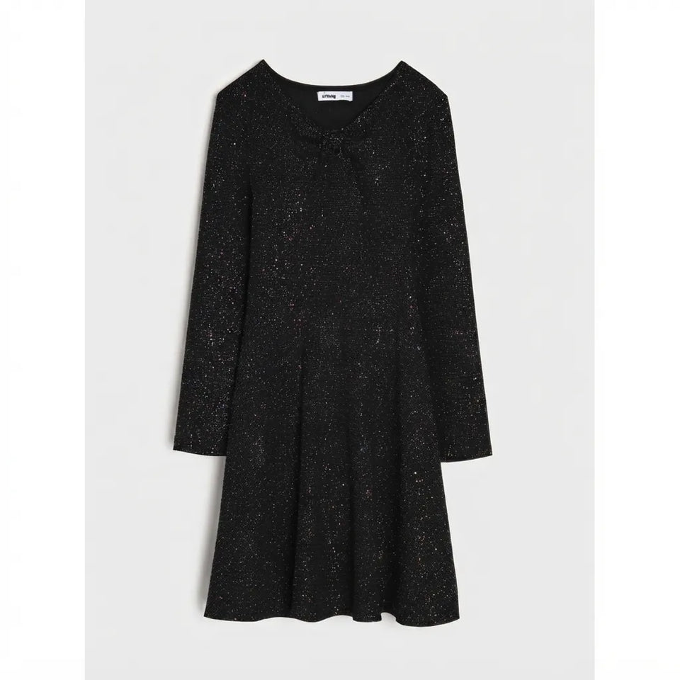 A black long-sleeve knit dress with a subtle silver glitter texture, featuring a V-neckline with a small bow detail at the center, a flared skirt, and a visible 'Miso' brand label inside the collar.
