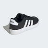 A black and white Adidas low-top sneaker shown from a three-quarters rear angle on a light gray background.