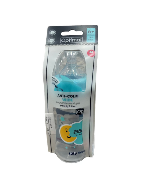 Baby bottle with packaging on a textured surface