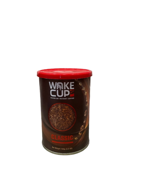 Can of Wake Cup Classic instant coffee on a textured surface with a stone wall background