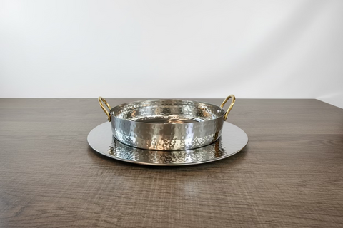 Silver metal tray with handles on a wooden surface