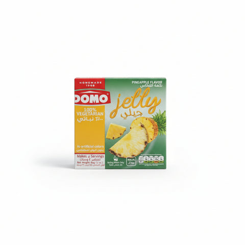 Hand holding a box of Domo pineapple jelly in a car.