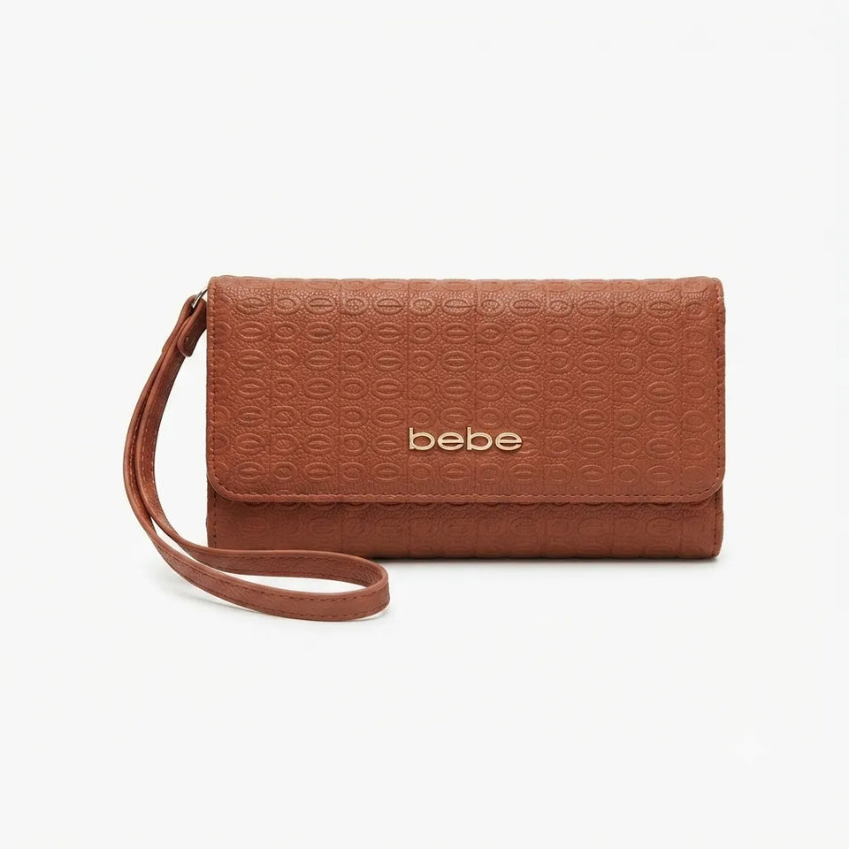 A brown textured leather clutch wallet with a wrist strap and the brand name 'bebe.' in gold lettering, shown on a light gray background.