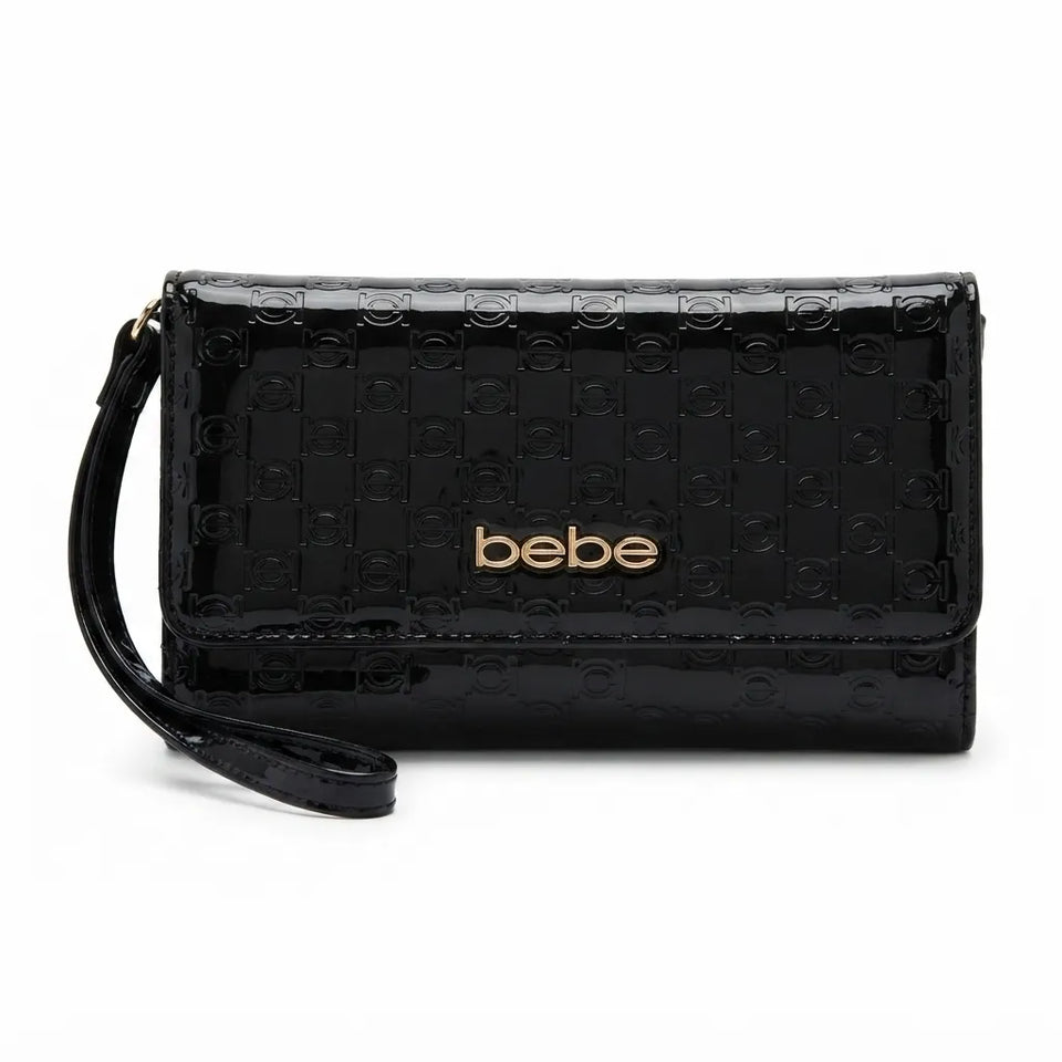A black patent leather clutch wallet with a wristlet strap, featuring a subtle embossed circular pattern and a gold-tone 'bebe' logo on the front, set against a plain white background.