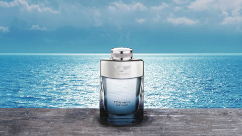 Perfume bottle on a wooden surface with a blue ocean and sky background