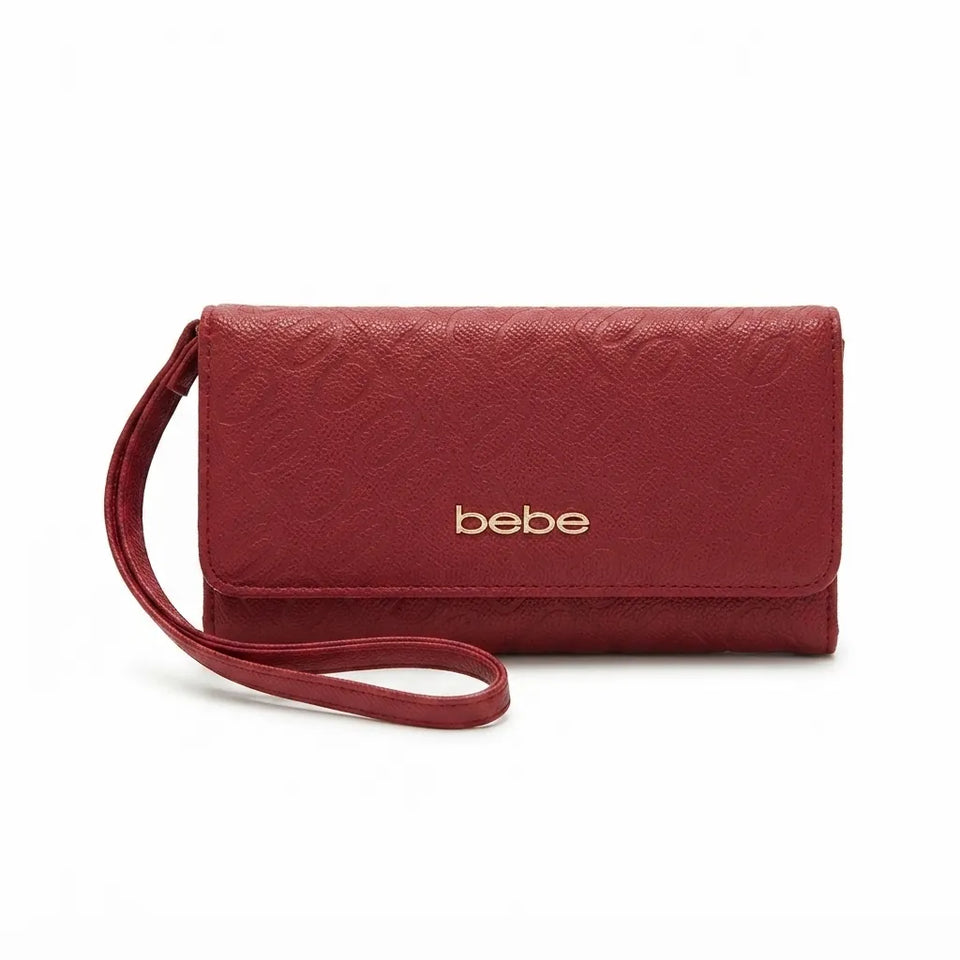 A red textured leather clutch wallet with a wrist strap and gold 'bebe' logo, shown on a plain white background.