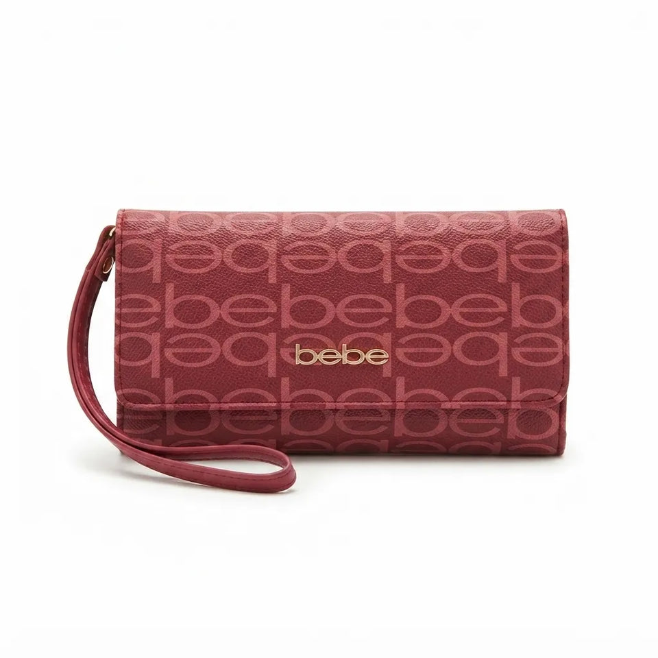 A burgundy leather clutch wallet with an allover tonal 'bebe' logo pattern and a gold-tone 'bebe' logo on the front, featuring a matching wristlet strap, set against a plain white background.