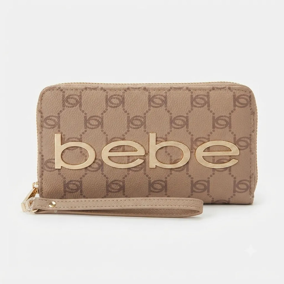 A beige monogram wallet with a wristlet strap and large gold-tone 'bebe' lettering on the front, set against a plain light gray background.