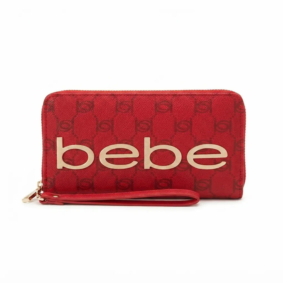 Red zip-around wallet with a wristlet strap, featuring a dark red monogram pattern and large gold 'bebe' lettering on the front, shown on a white background.