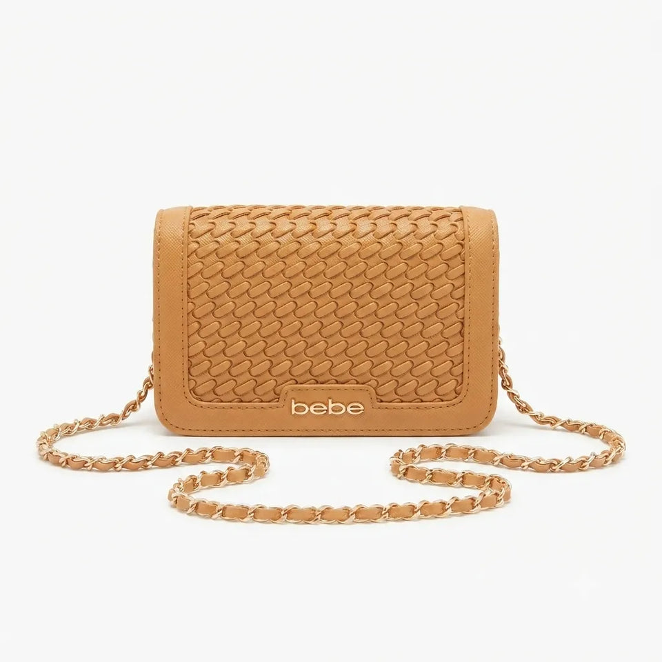 A tan woven leather crossbody bag with a gold-tone chain strap and a small 'bebe' logo plaque on the front, set against a plain white background.
