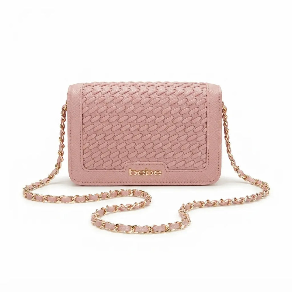 A pink woven leather crossbody bag with a gold-tone chain strap and a gold 'bebe' logo on the front, displayed on a clean white background.