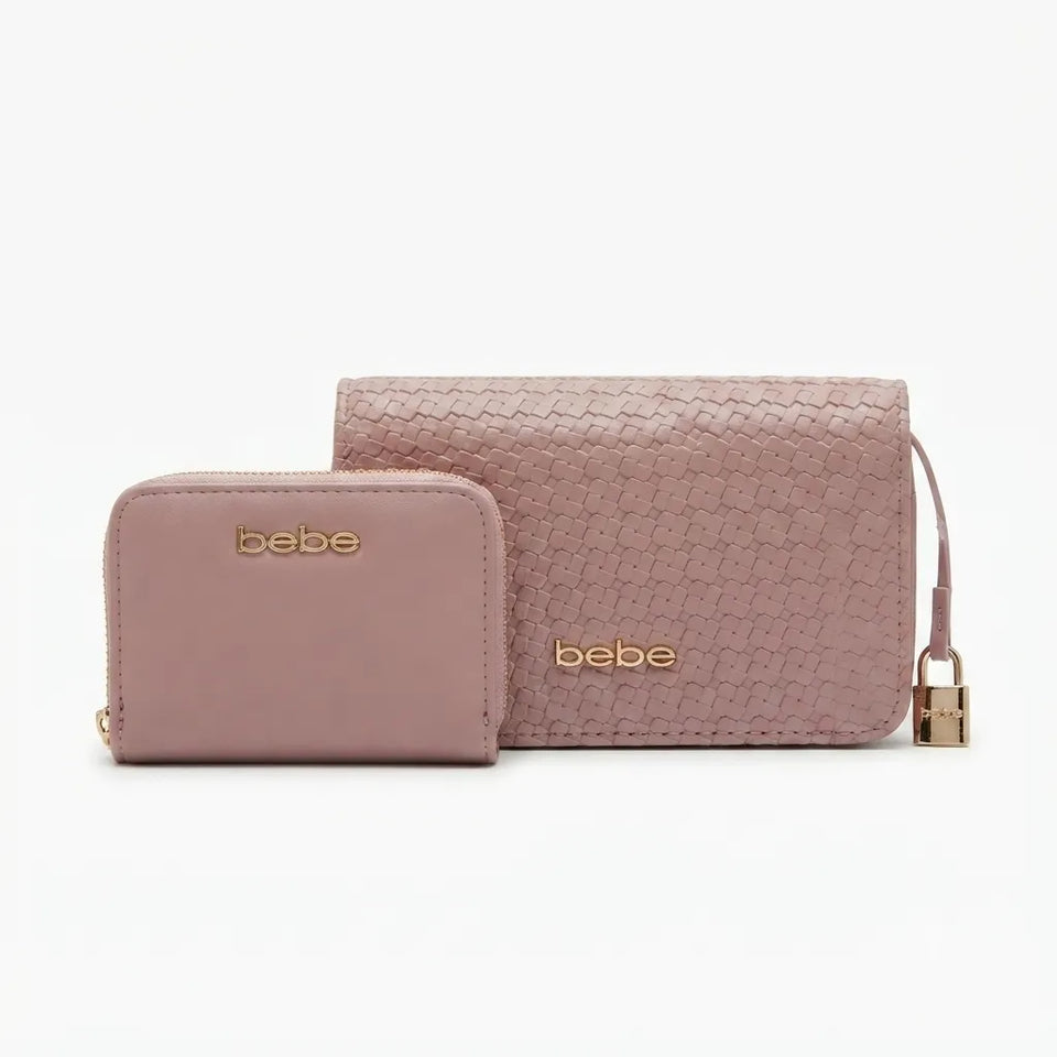 A dusty pink textured leather wallet set by bebe, featuring a larger zip-around wallet with a wrist strap and padlock, and a smaller matching zip card case, both with gold-tone 'bebe' logos, on a white background.