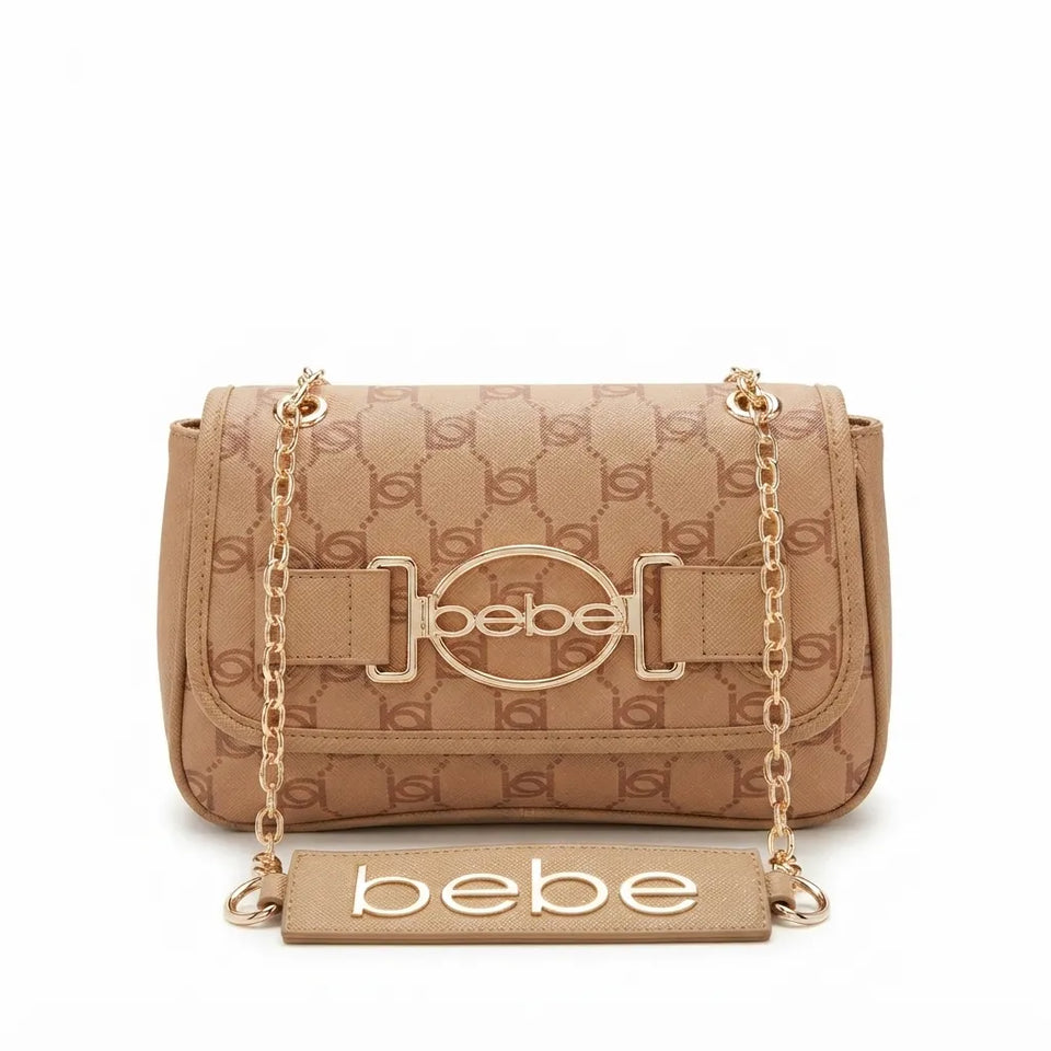 A beige monogrammed leather shoulder bag with gold-tone hardware, featuring a front strap closure with the brand name 'bebe' in the center and a matching rectangular 'bebe' plaque in front, set against a plain white background.