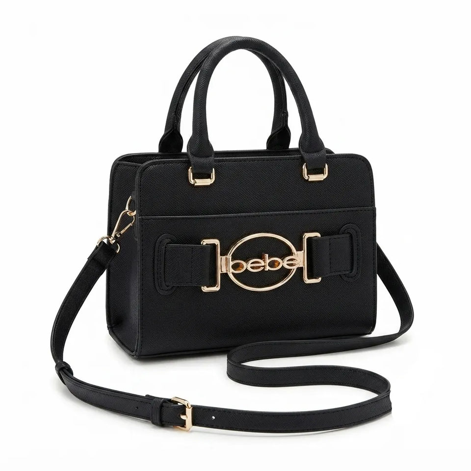 A black leather handbag with gold-tone hardware, featuring a top handle, a detachable shoulder strap, and a prominent oval buckle on the front with the brand name 'bebe!' in gold lettering, set against a plain white background.