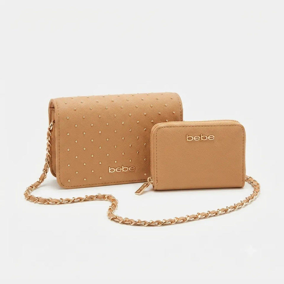 A tan faux-leather crossbody bag with a matching zip-around wallet, both featuring the 'bebe' logo and a gold-tone chain strap, set against a light gray background.