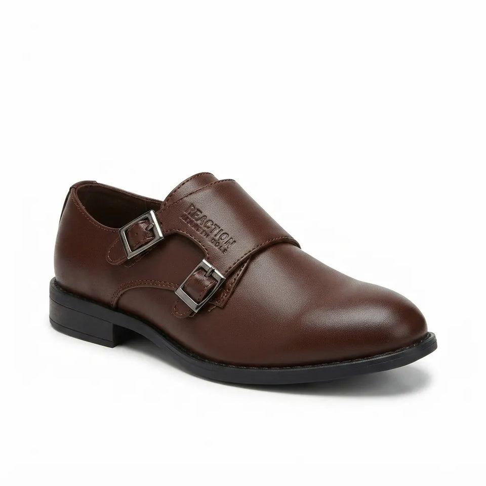 A single brown leather double-strap loafer-style shoe with silver-tone buckle hardware and a black sole, photographed on a clean white background.