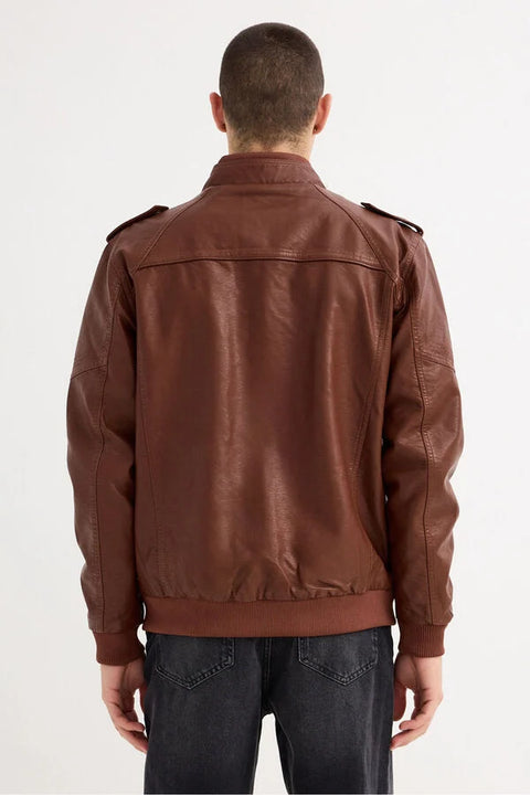 Brown leather jacket worn by a person on a white background