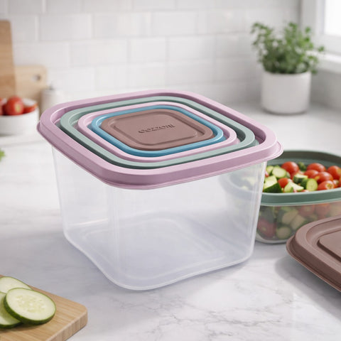 Set of silicone food storage containers on a kitchen counter with vegetables in the background.