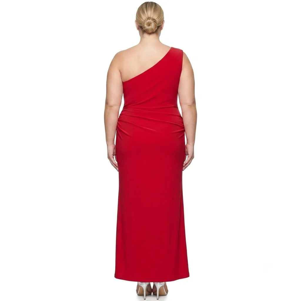 A woman viewed from the back wearing a bright red one-shoulder maxi dress with a gathered waist, paired with metallic high heels, against a plain white background.