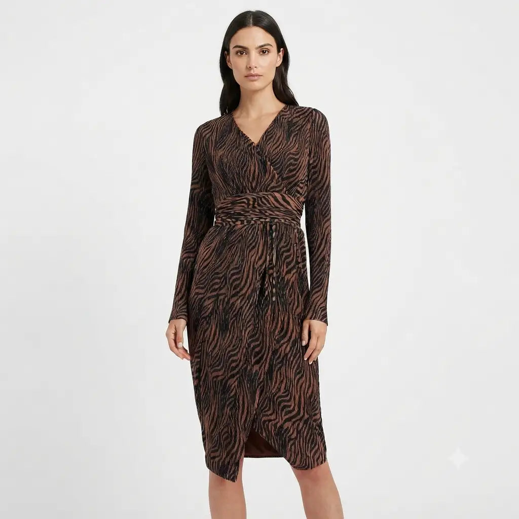 A woman modeling a long-sleeve wrap-style midi dress with a brown and black zebra-like animal print pattern, set against a plain light gray studio background.